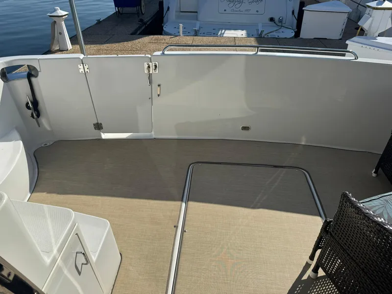 Slide: The Image of 2001 Carver 450 Voyager Pilothouse deck with seating and railing. - 10