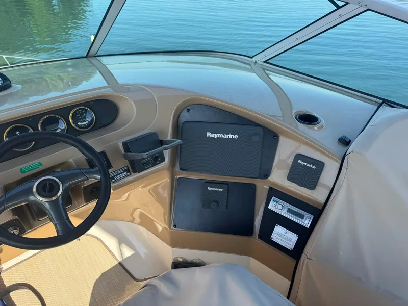 Slide: The Image of 2001 Carver 450 Voyager Pilothouse helm with Raymarine electronics, steering wheel, and gauges. - 16