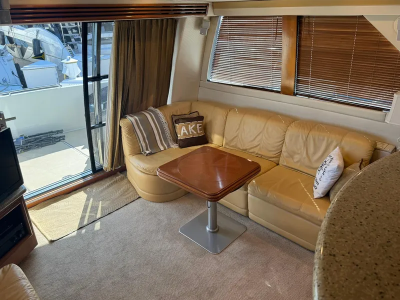 Slide: The Image of Interior of 2001 Carver 450 Voyager Pilothouse with leather seating and wooden table. - 22