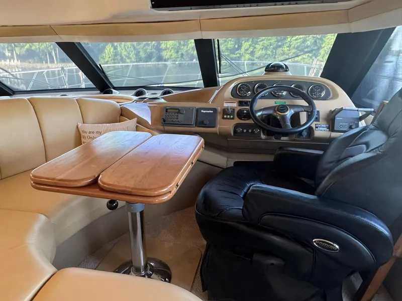 Slide: The Image of Interior of 2001 Carver 450 Voyager Pilothouse with helm, leather seating, and wooden table. - 25