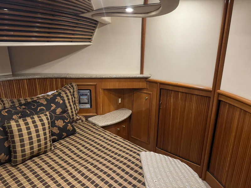 Slide: The Image of Luxurious interior of 2001 Carver 450 Voyager Pilothouse with elegant wood paneling and patterned bedding. - 35