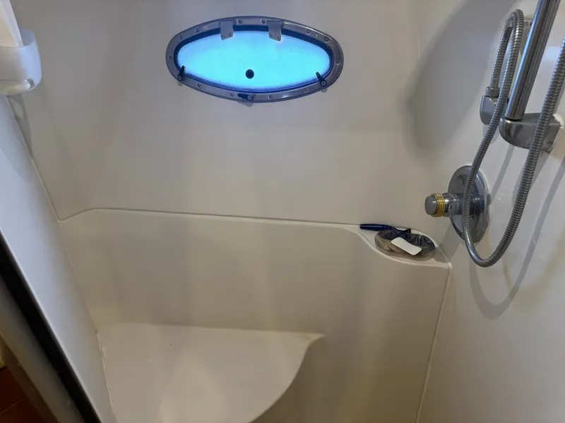 Slide: The Image of Shower area in 2001 Carver 450 Voyager Pilothouse with porthole and handheld showerhead. - 39