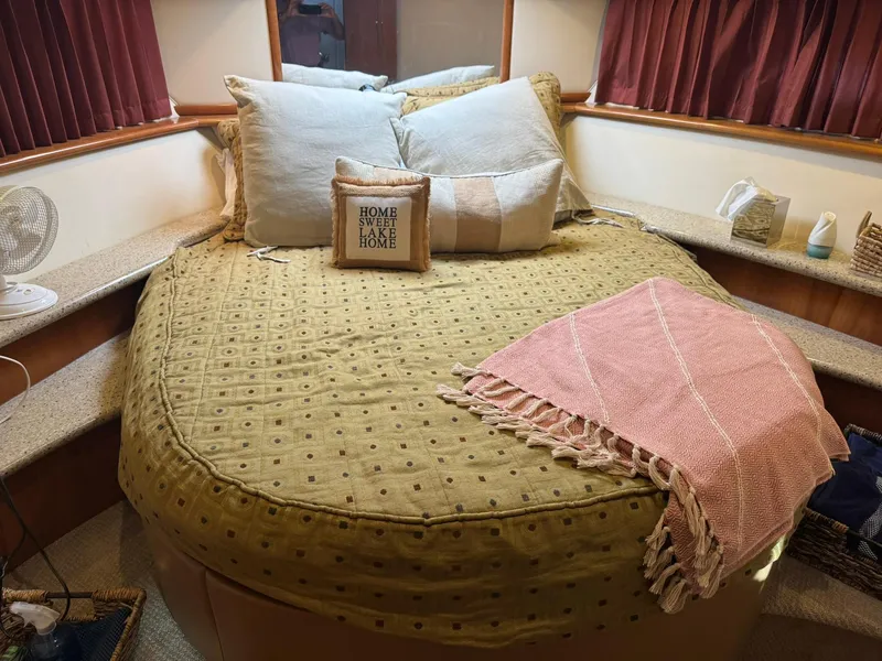 Slide: The Image of Cozy bedroom in 2001 Carver 450 Voyager Pilothouse with decorative pillows and blanket. - 40