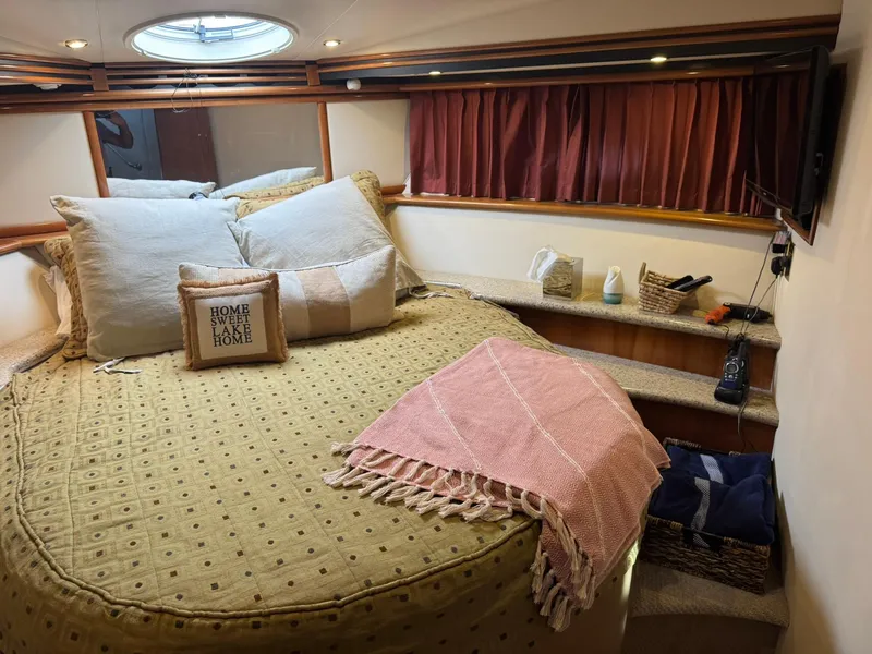 Slide: The Image of Cozy bedroom in 2001 Carver 450 Voyager Pilothouse with decorative pillows and blanket. - 41