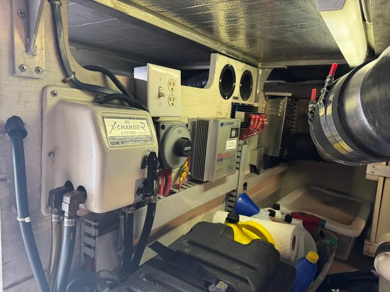 Slide: The Image of Engine room of 2001 Carver 450 Voyager Pilothouse with oil changer system and electrical components. - 48