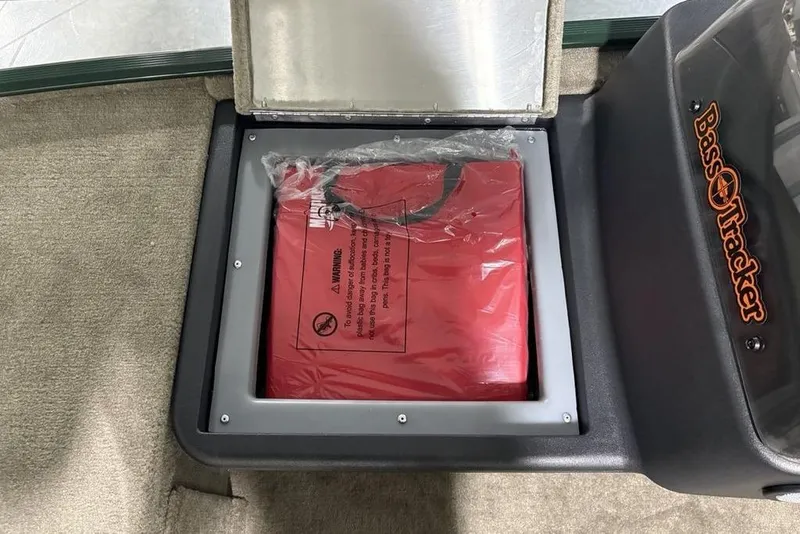 Slide: The Image of Storage compartment in 2026 Tracker Bass Tracker® Classic Limited boat with red life jacket. - 12