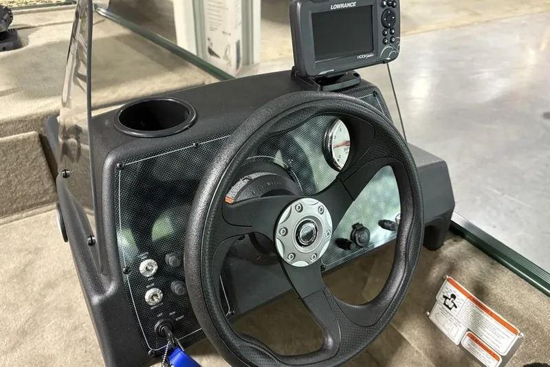 Slide: The Image of 2026 Tracker Bass Tracker® Classic Limited dashboard with steering wheel and fish finder. - 13