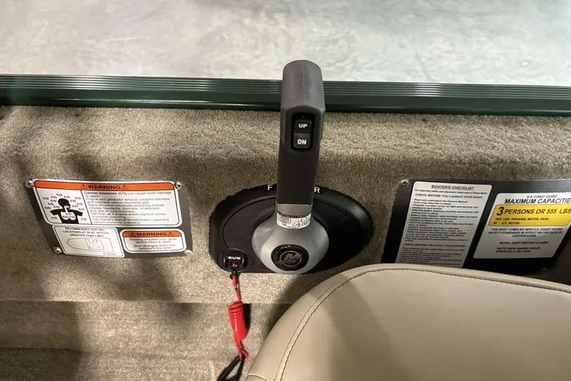 Slide: The Image of Control panel of 2026 Tracker Bass Tracker® Classic Limited boat with safety warnings. - 17