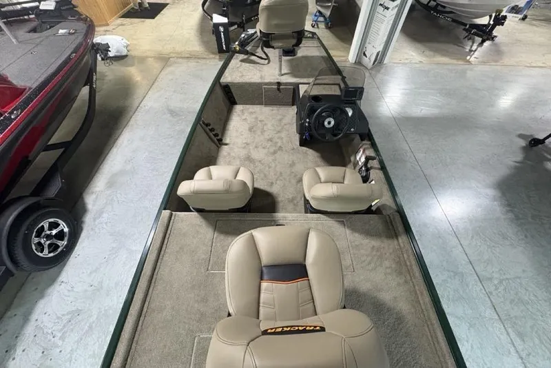 Slide: The Image of 2026 Tracker Bass Tracker® Classic Limited boat interior with beige seating and steering console. - 20