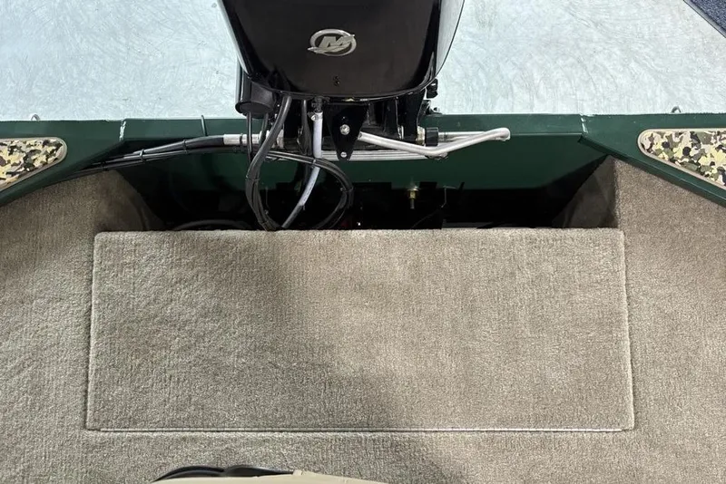 Slide: The Image of 2026 Tracker Bass Tracker® Classic Limited boat interior with motor and carpeted flooring. - 21