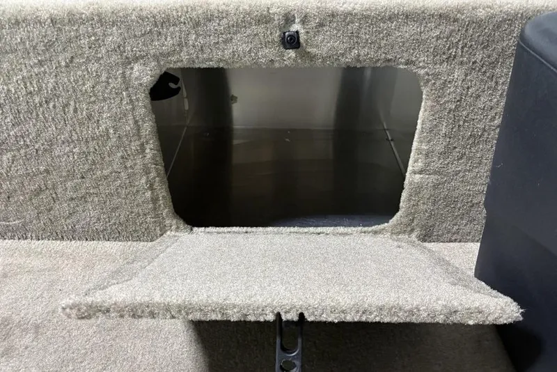 Slide: The Image of 2026 Tracker Bass Tracker® Classic Limited storage compartment with carpeted interior. - 7