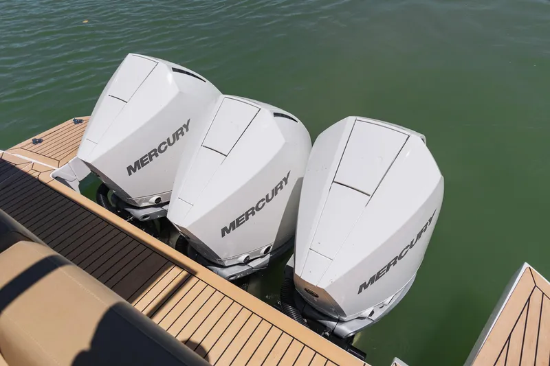 Slide: The Image of Three Mercury outboard engines on a 2025 Pardo Yachts 38, docked on calm water. - 31