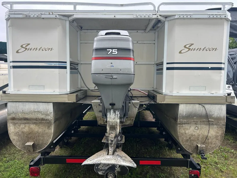 Slide: The Image of 1996 JC Suntoon 24 pontoon boat with 75 HP outboard motor, rear view. - 3