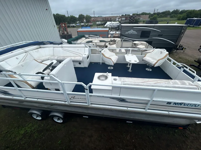 Slide: The Image of 1996 JC Suntoon 24 pontoon boat with white seating and blue flooring. - 6