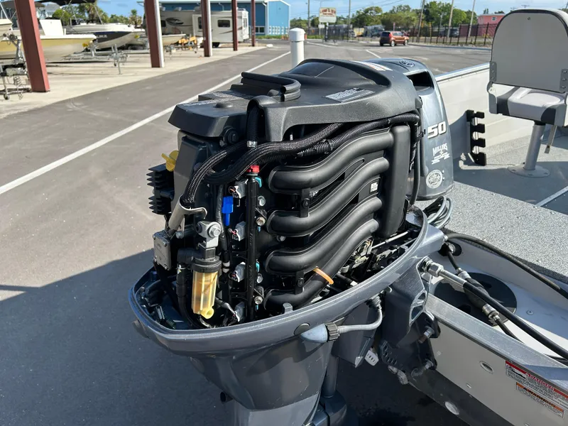 Slide: The Image of 2020 Smoker Craft Angler 16 XL SC boat with open storage compartment and trolling motor. - 11