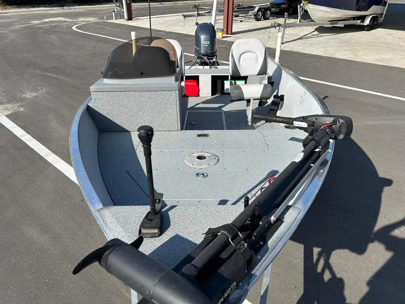 Slide: The Image of 2020 Smoker Craft Angler 16 XL SC boat with canopy and motor, parked in a marina. - 6