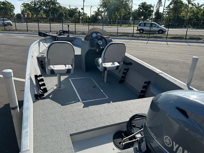 Slide: The Image of 2020 Smoker Craft Angler 16 XL SC boat with Yamaha motor, parked on pavement. - 7