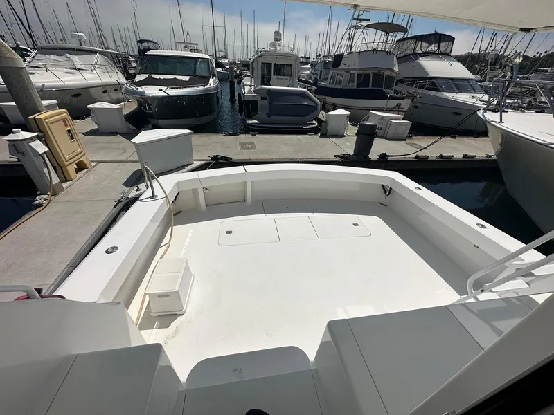 Slide: The Image of 2000 Viking Enclosed Flybridge yacht docked at marina, spacious deck view. - 10