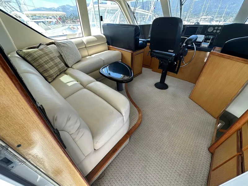 Slide: The Image of Luxurious interior of 2000 Viking Enclosed Flybridge yacht with plush seating and helm. - 16