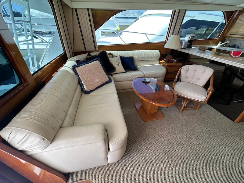 Slide: The Image of Luxurious interior of 2000 Viking Enclosed Flybridge yacht with plush seating and elegant decor. - 18