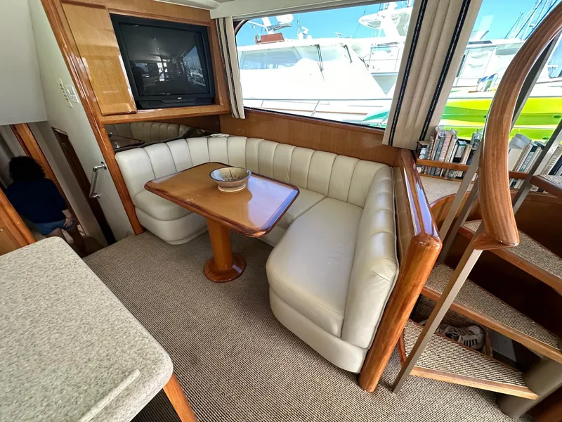 Slide: The Image of Luxurious interior of 2000 Viking Enclosed Flybridge yacht with plush seating and wooden accents. - 19