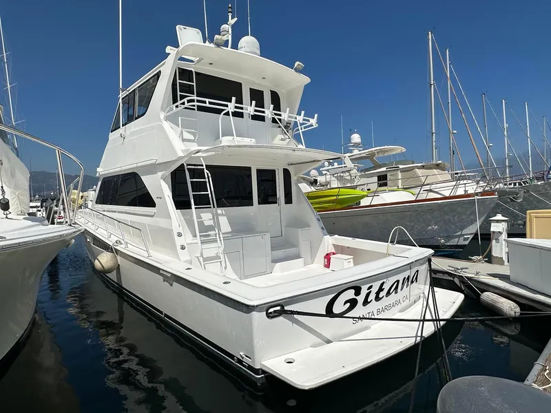 Slide: The Image of 2000 Viking Enclosed Flybridge yacht docked in marina, clear sky, Santa Barbara. - 2