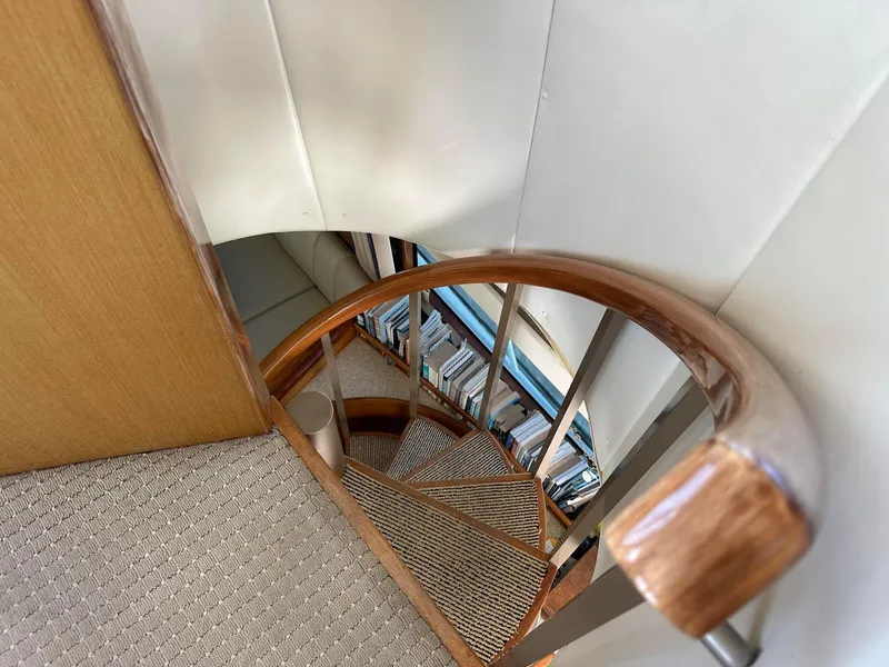 Slide: The Image of Staircase inside 2000 Viking Enclosed Flybridge yacht with wooden handrail and carpeted steps. - 21