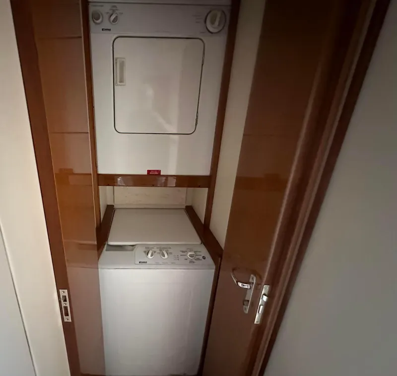 Slide: The Image of Stacked washer and dryer in 2000 Viking Enclosed Flybridge yacht interior. - 30