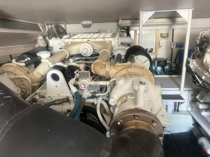 Slide: The Image of Engine room of a 2000 Viking Enclosed Flybridge yacht, showcasing mechanical components. - 33