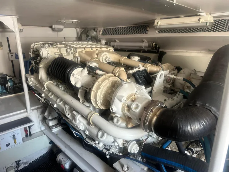 Slide: The Image of Engine room of a 2000 Viking Enclosed Flybridge yacht, showcasing a powerful marine engine. - 34