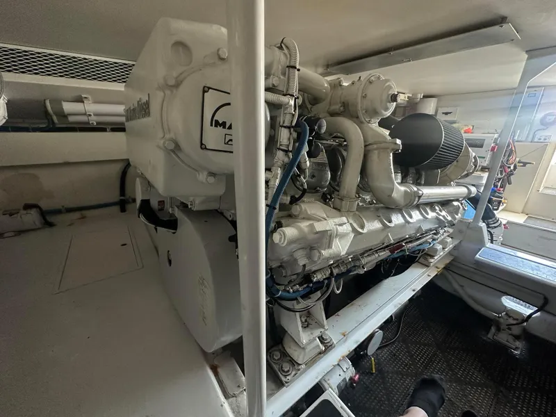 Slide: The Image of Engine room of a 2000 Viking Enclosed Flybridge yacht, featuring a powerful marine diesel engine. - 36