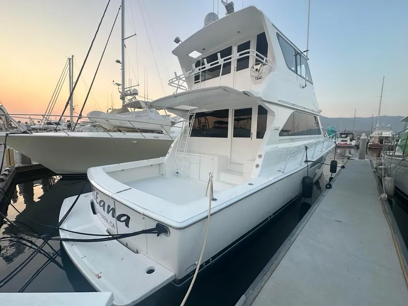 Slide: The Image of 2000 Viking Enclosed Flybridge yacht docked at marina during sunset. - 4