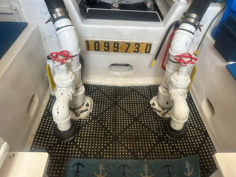 Slide: The Image of Engine room of a 2000 Viking Enclosed Flybridge with visible piping and valves. - 40