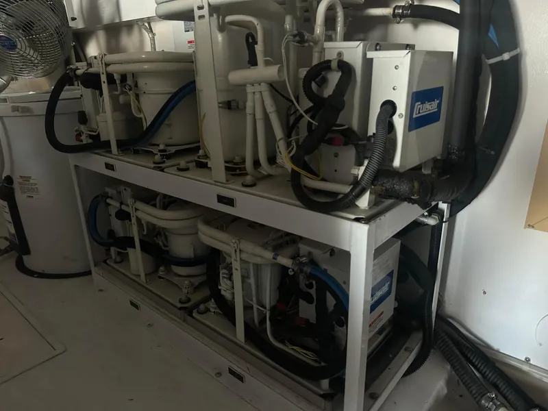 Slide: The Image of Engine room of a 2000 Viking Enclosed Flybridge yacht with mechanical equipment and piping. - 43