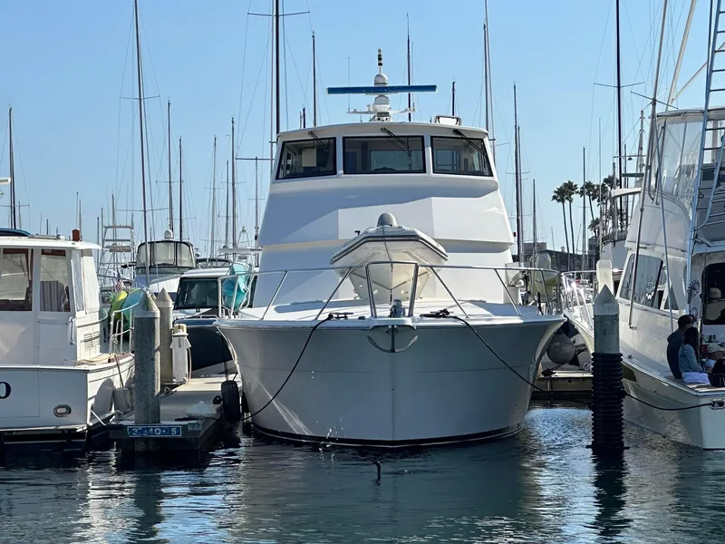 Slide: The Image of 2000 Viking Enclosed Flybridge yacht docked at marina, surrounded by other boats. - 6