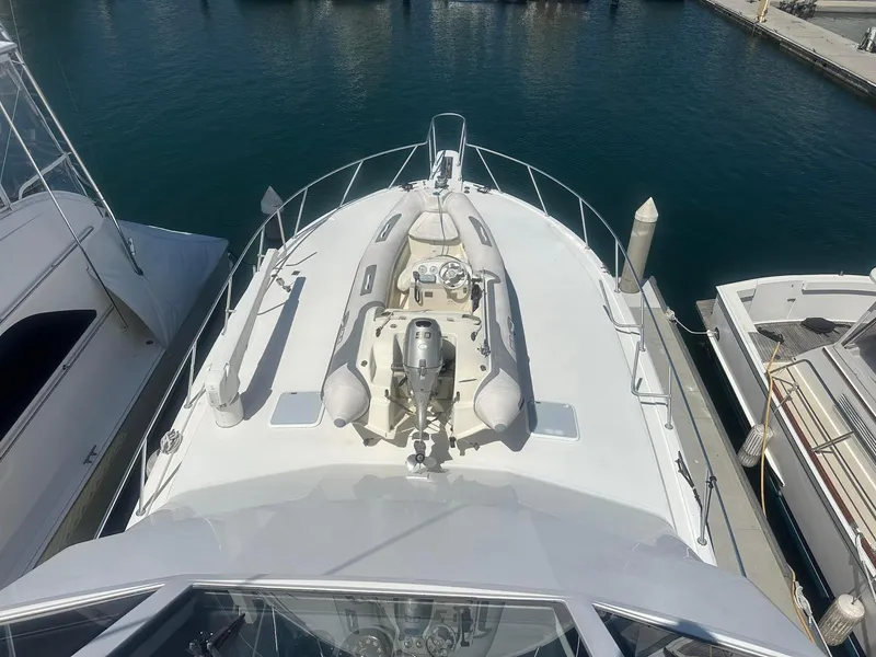 Slide: The Image of 2000 Viking Enclosed Flybridge yacht docked at marina, top view. - 8