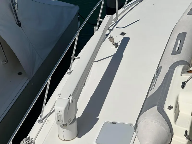 Slide: The Image of 2000 Viking Enclosed Flybridge deck with inflatable boat and railing. - 9