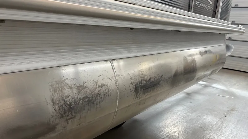 Slide: The Image of Close-up of a Bennington pontoon with scratches on the aluminum hull. - 28