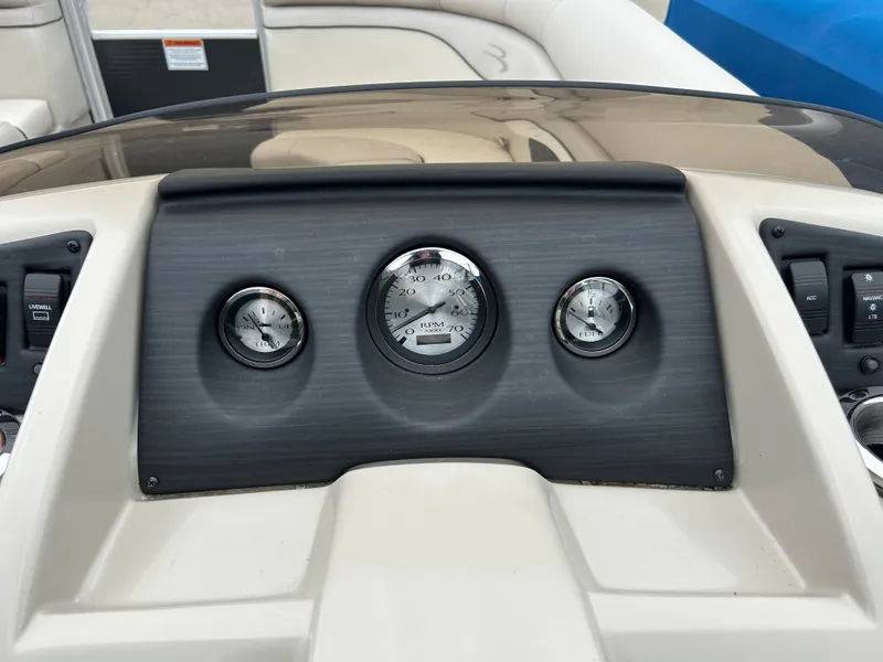 Slide: The Image of The dashboard of a 2019 Bennington 20SSRCX with three round gauges. - 9