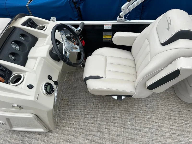 Slide: The Image of The image shows the cockpit of a 2019 Bennington 20SSRCX with a comfortable helm seat. - 7
