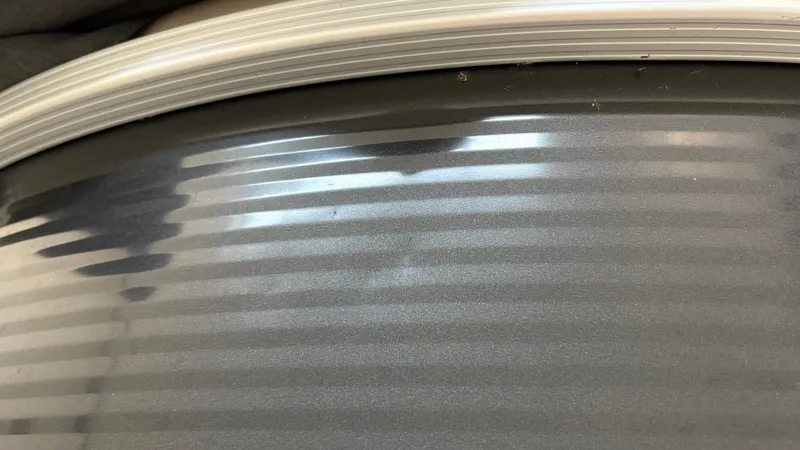 Slide: The Image of Close-up of a textured metal area with a curved edge. - 26