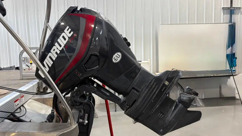 Slide: The Image of An Evinrude outboard motor is mounted on a boat situated indoors. - 15