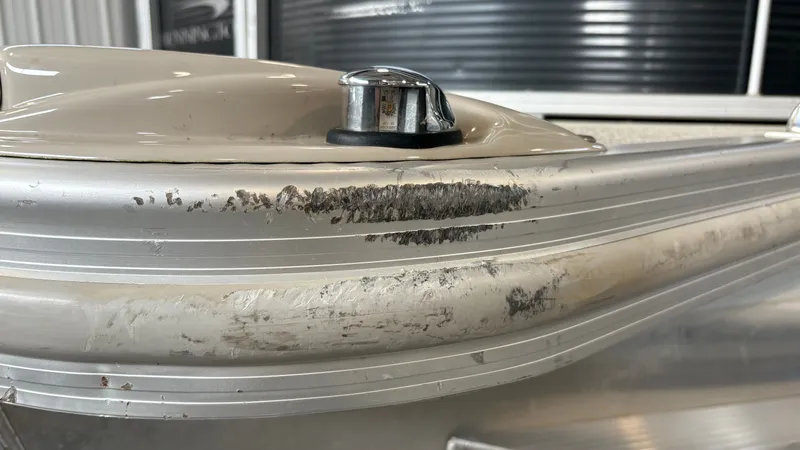 Slide: The Image of Close-up of a damaged boat area with scratches and dents on the aluminum. - 21