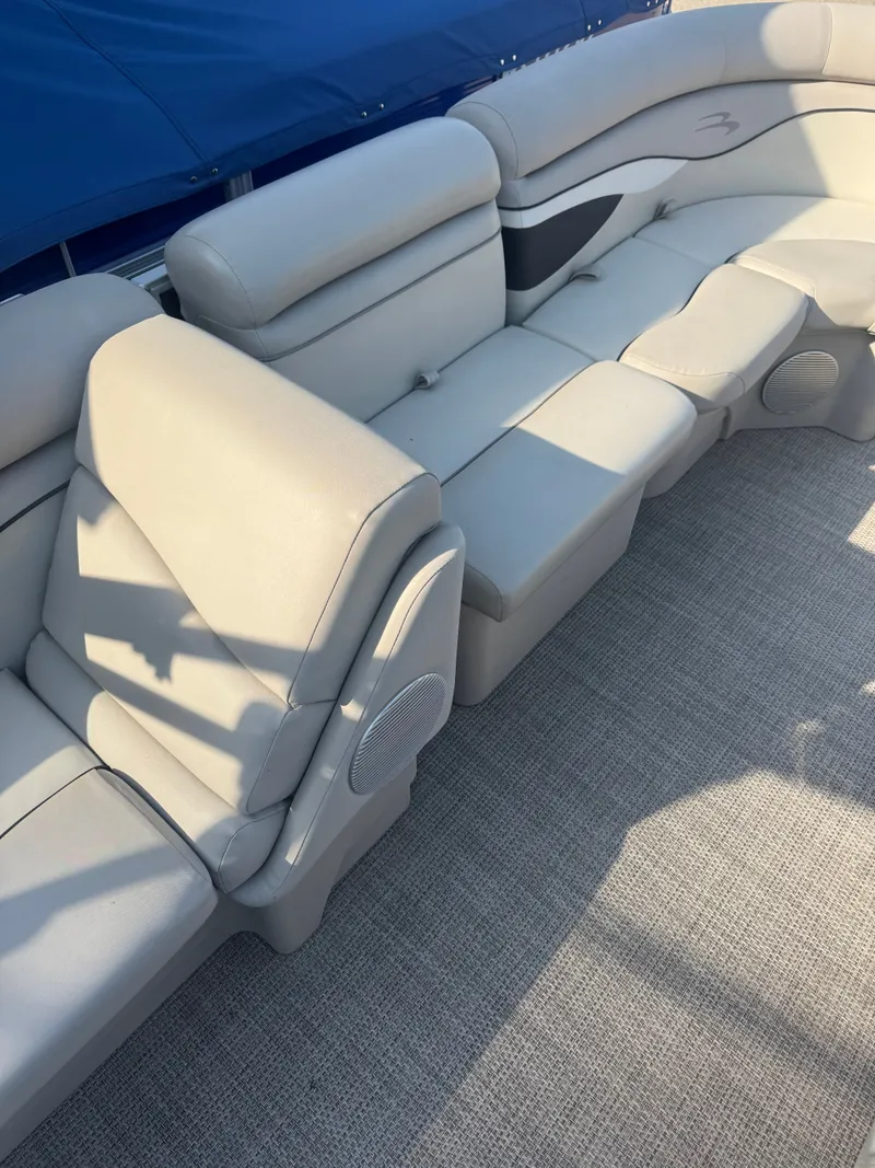 Slide: The Image of The image shows the seating area of a 2019 Bennington 20SSRCX pontoon boat. - 19