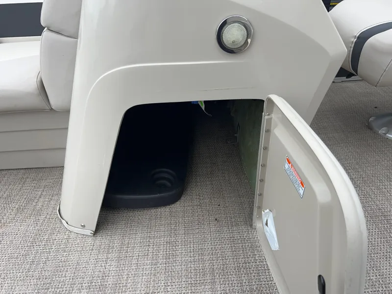 Slide: The Image of Storage compartment under the seat on a 2019 Bennington 20SSRCX pontoon boat. - 32