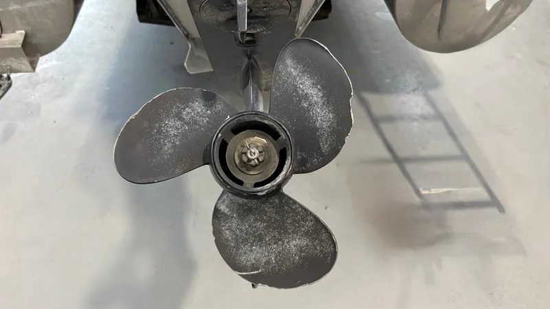 Slide: The Image of Close-up of a three-blade boat propeller, slightly worn, on a concrete floor. - 16