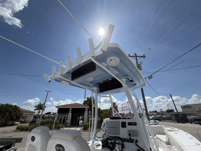 Slide: The Image of 2020 Blue Wave 2800 Makaira boat with sun canopy and helm console. - 22