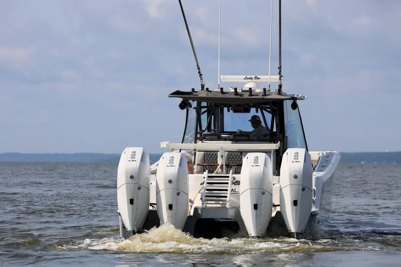 Slide: The Image of 2022 Invincible 46 Catamaran with four outboard engines cruising on open water. - 17