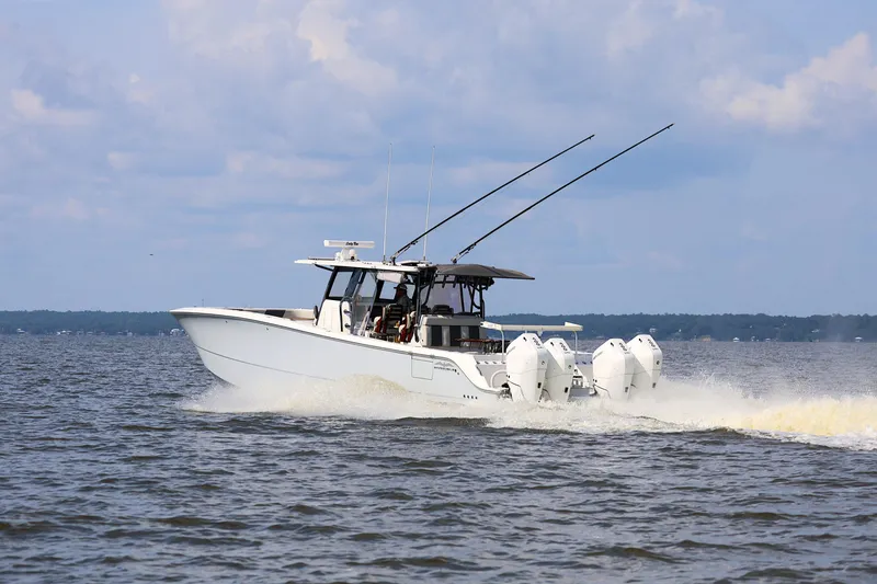 Slide: The Image of 2022 Invincible 46 Catamaran cruising on open water under a cloudy sky. - 5