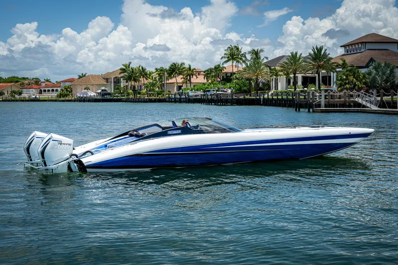 Slide: The Image of 2023 Performance Powerboats P360 on water, luxury waterfront homes in background. - 11